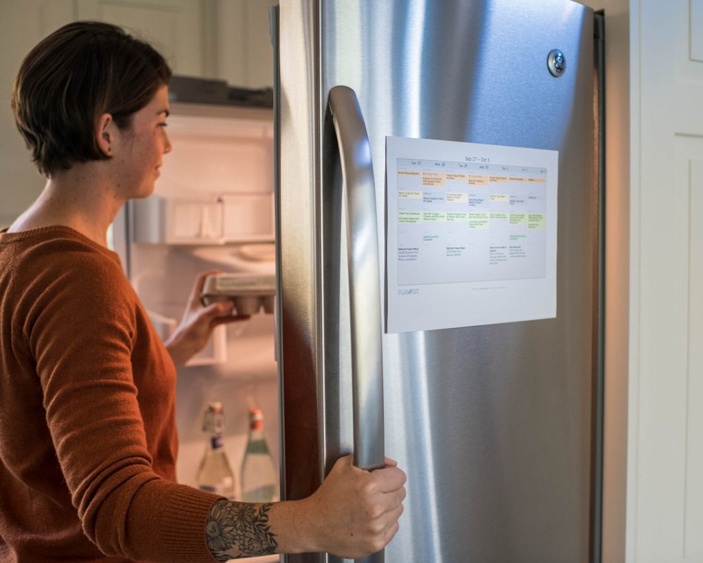 cropped image of a woman looking in a refrigerator