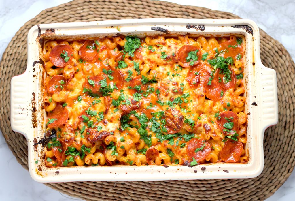 Flat lay composition of a casserole with cheese and pepperonis