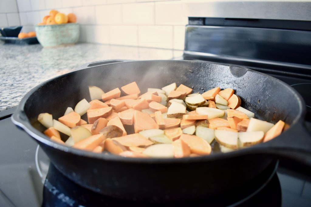 potatoes sauteing in a cast iron pan