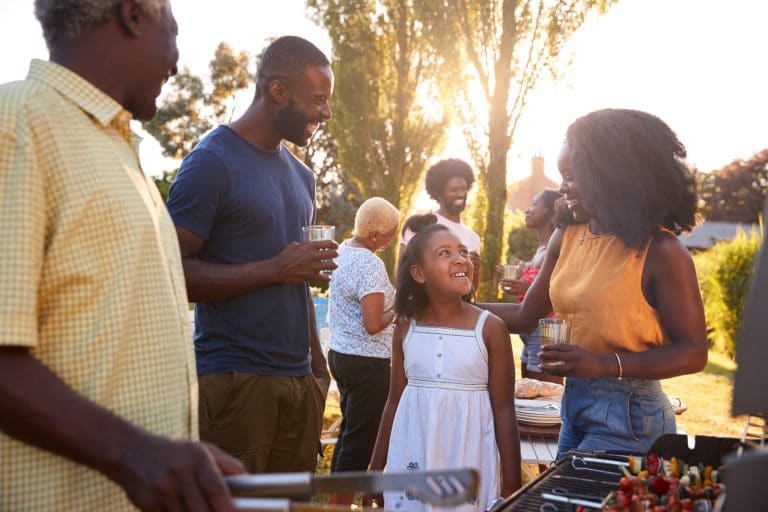 Parents and daughter at a multi generation family barbecue