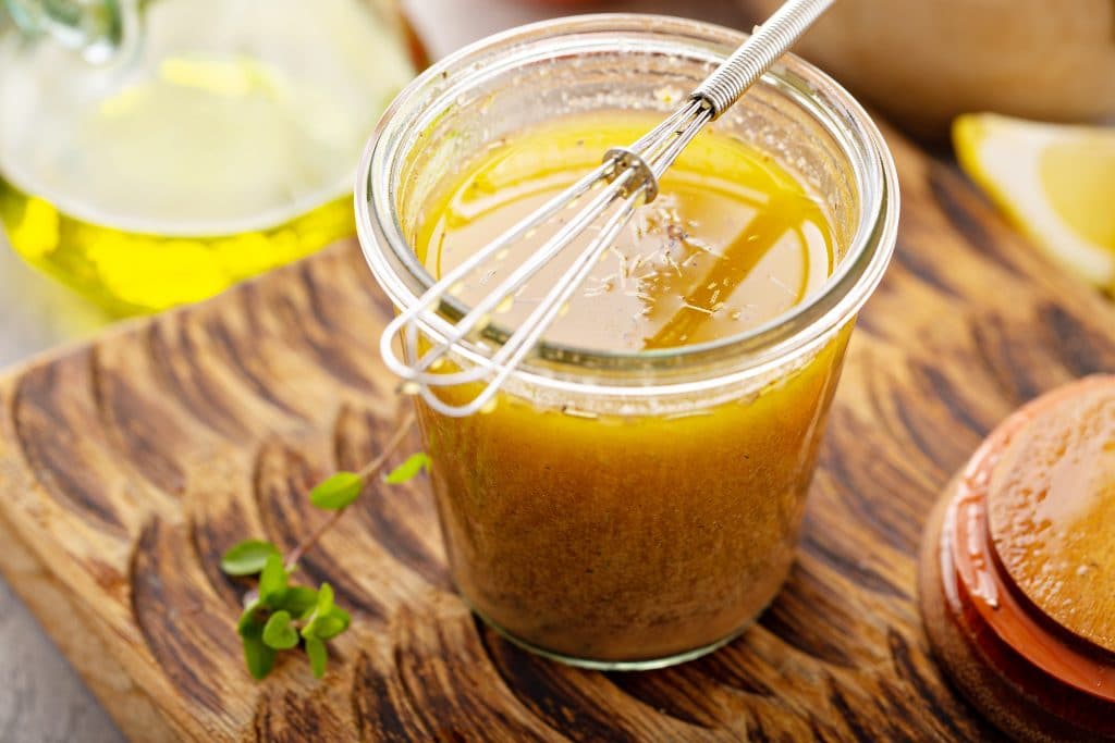 Homemade greek salad dressing or marinade in a glass jar