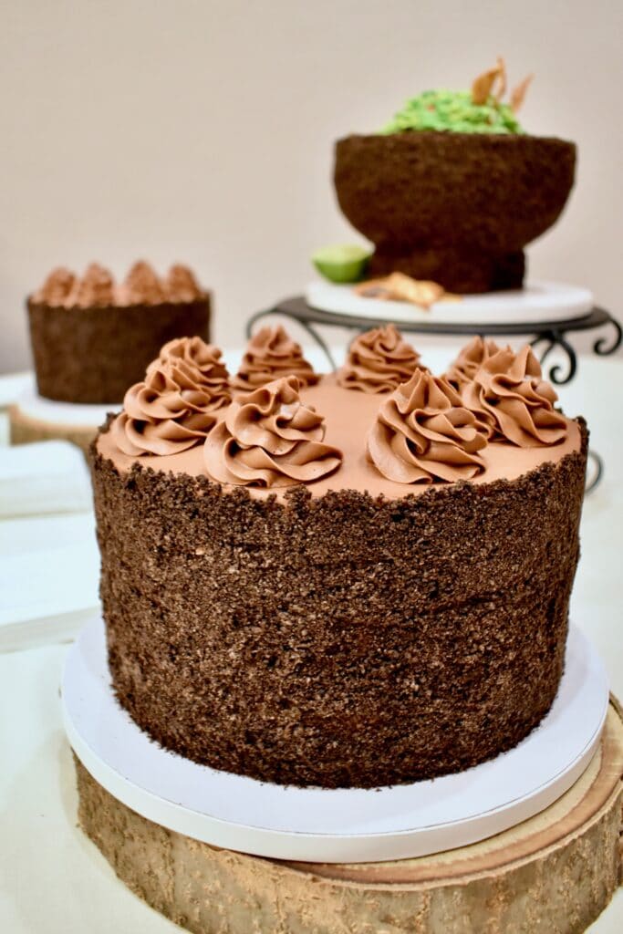 image of chocolate cake with two smaller cakes in the background