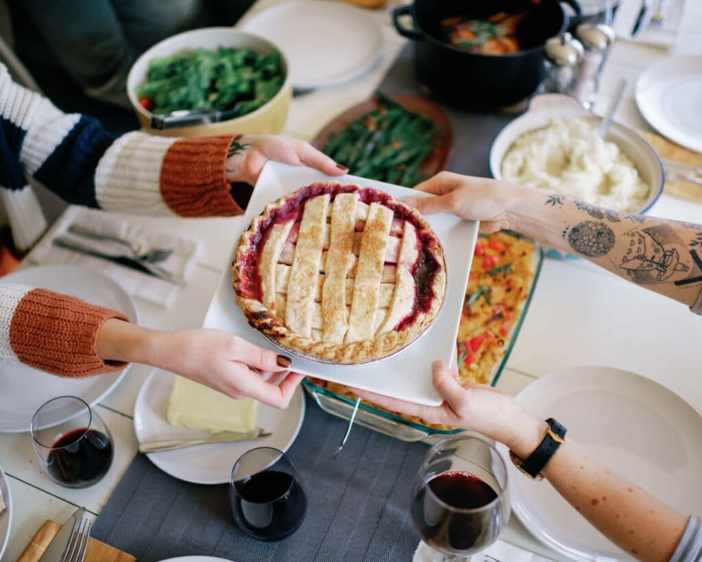 close up of pie being passed between two people