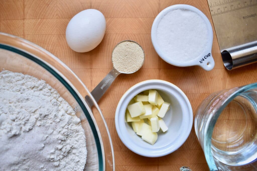 overhead shot of ingredients for homemade hamburger buns in individual containers