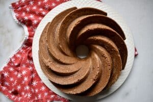 overhead shot of spiced bundt cake with a red holiday napkin on a white surface